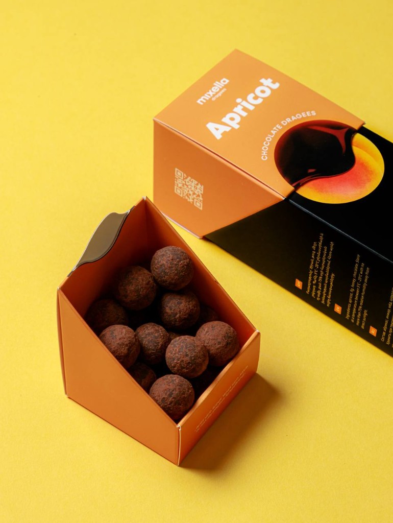 Open Mixella apricot chocolate dragees tray of cocoa-dusted pieces