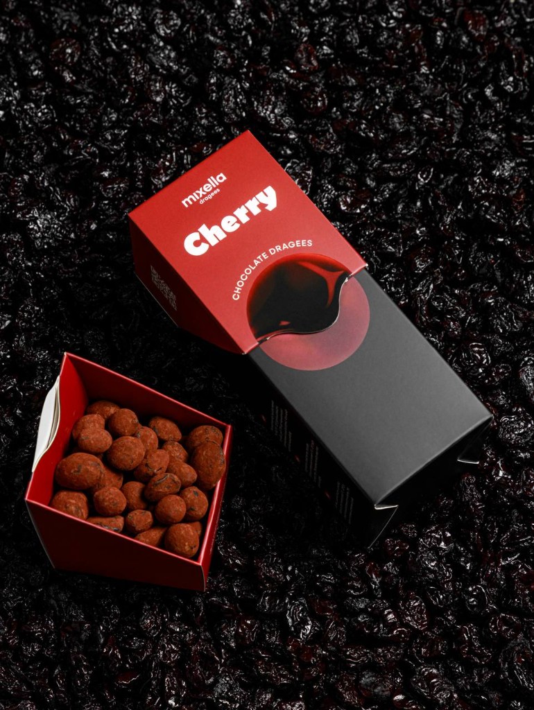 Mixella cherry chocolate dragees on a bed of dried cherries